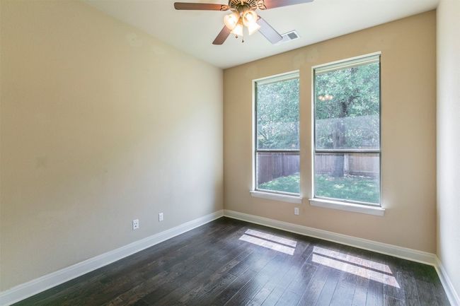 Unfurnished room featuring wood floors, ceiling fan, baseboards, and plenty of natural light | Image 36