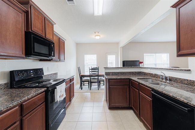 Another view of the kitchen looking towards the breakfast room. | Image 13