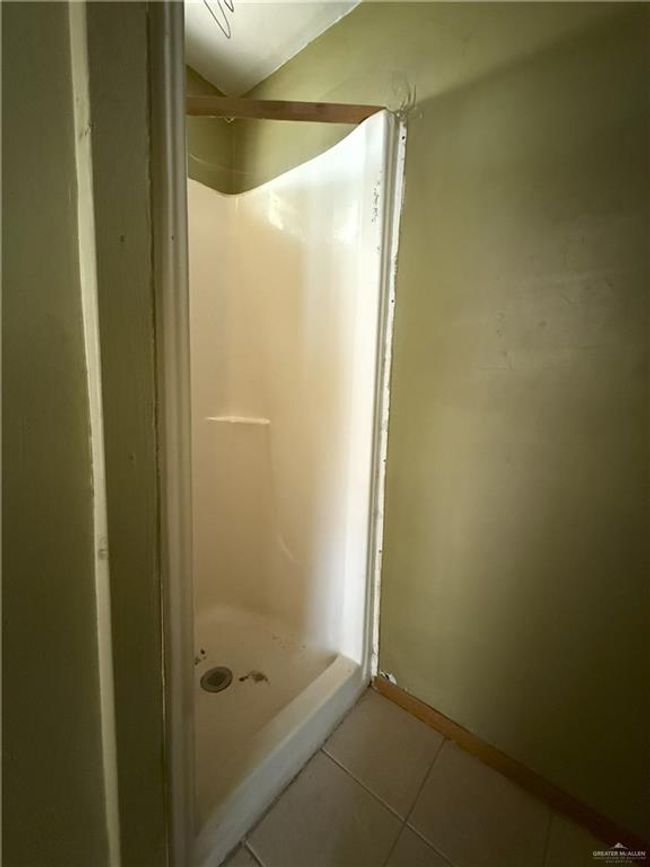 Full bathroom with tile patterned floors, a shower stall, and baseboards | Image 22