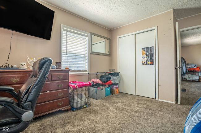 carpeted office with a textured ceiling | Image 17
