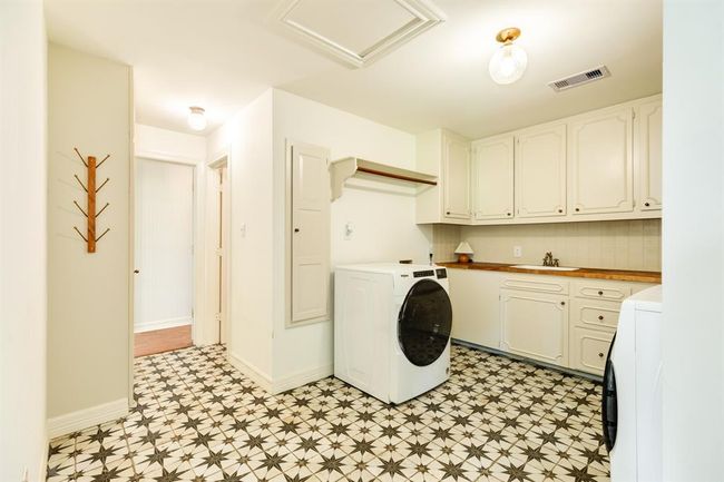 Convenient in-home laundry room featuring beautiful flooring, adding both style and functionality. | Image 35