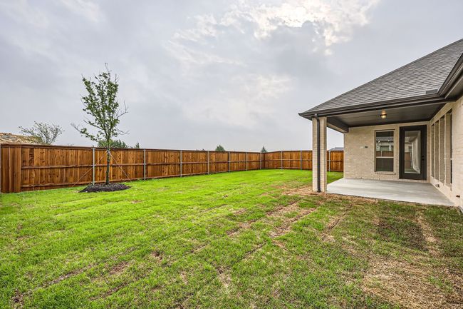 View of yard with a fenced backyard and a patio area | Image 27
