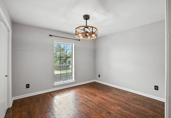 Spare room featuring a chandelier and dark wood-style flooring | Image 16