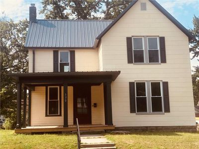 View of front of house with covered porch and a front lawn | Image 1