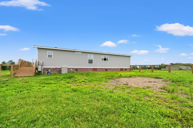 Rear view of property featuring crawl space and stairway | Image 29