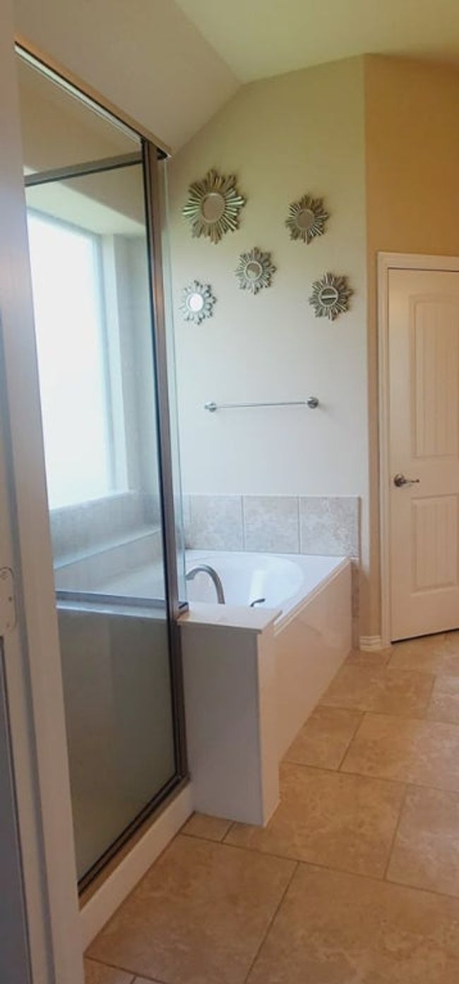 Full bath featuring a garden tub, lofted ceiling, a stall shower, and tile flooring | Image 13