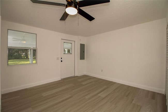 Bright primary bedroom with laundry | Image 13