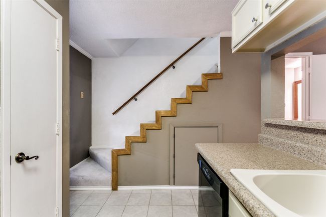 Staircase with tile patterned floors and baseboards | Image 15