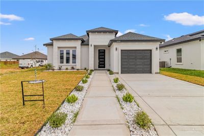 Prairie-style house with cooling unit, a front yard, and a garage | Image 2