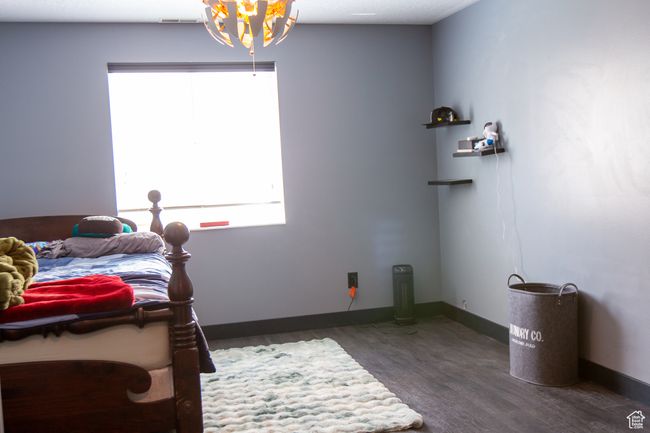 Bedroom with window, new LVP flooring, new light fixture, and baseboards | Image 27