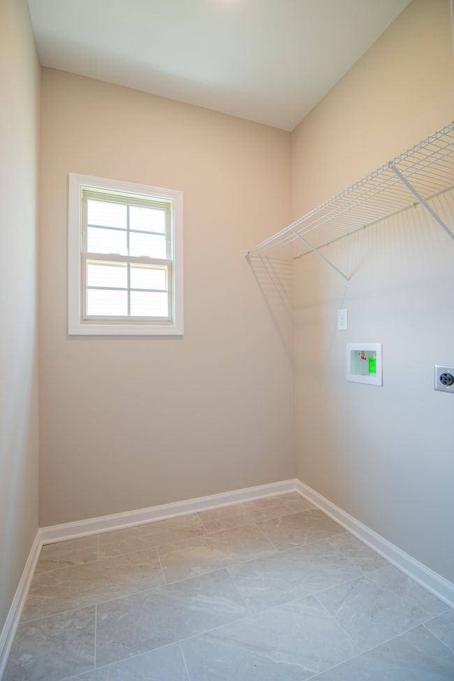 Spacious Laundry Room with Tile Flooring and Shelving!! | Image 18