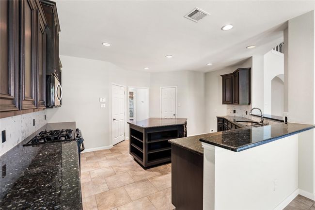 Along with ample storage space, kitchen also offers full size walk in pantry and garage access. | Image 12