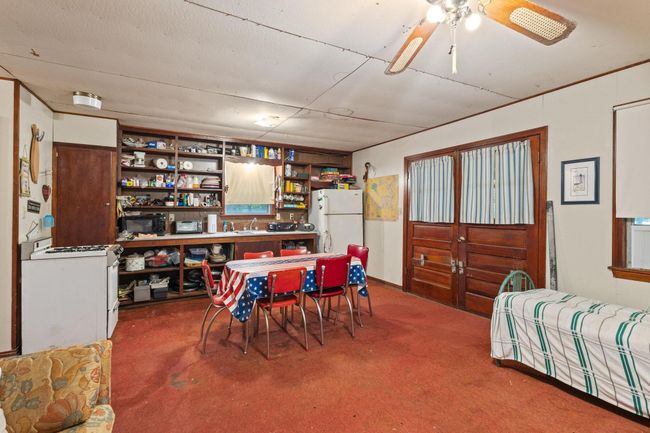 Carpeted dining room with a sink and a ceiling fan | Image 26