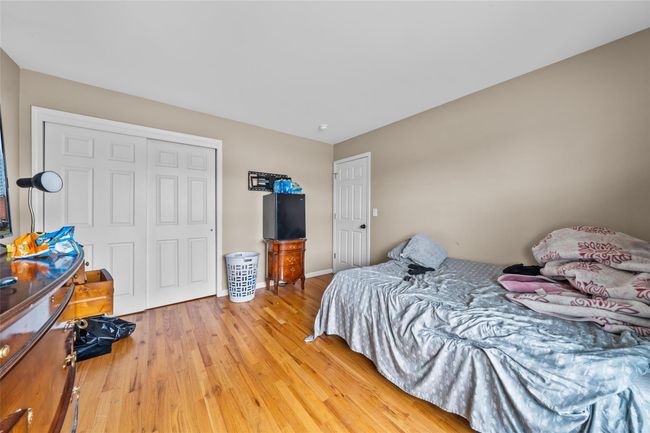 Bedroom with light wood finished floors, a closet, and baseboards | Image 37