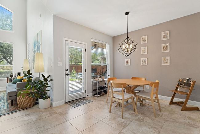 Informal dining area situated off the kitchen provides a serene backyard view. | Image 15