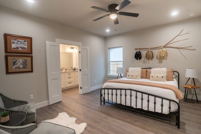 Bedroom featuring baseboards, recessed lighting, ensuite bath, dark wood-type flooring, and a sink | Image 13