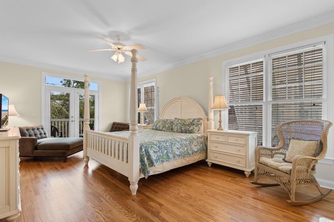 Bedroom with access to exterior, wood finished floors, crown molding, and ceiling fan | Image 14