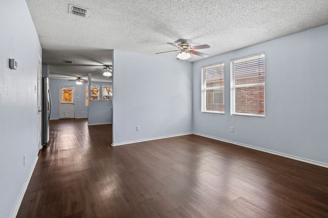 Spare room with ceiling fan, dark hardwood / wood-style floors, and a textured ceiling | Image 5