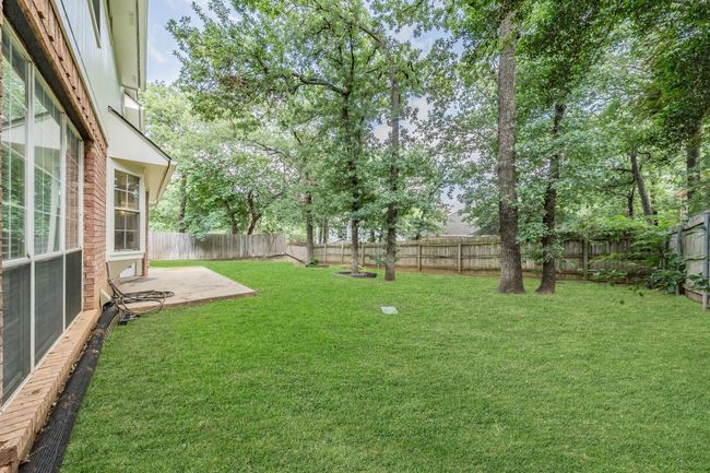 Backyard with open porch & beautiful shade trees! Lawn has been digitally enhanced. | Image 38