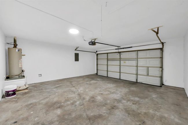 Garage big enough for two vehicles. Water heater is on the left. 16'x7' garage door with opener. | Image 37