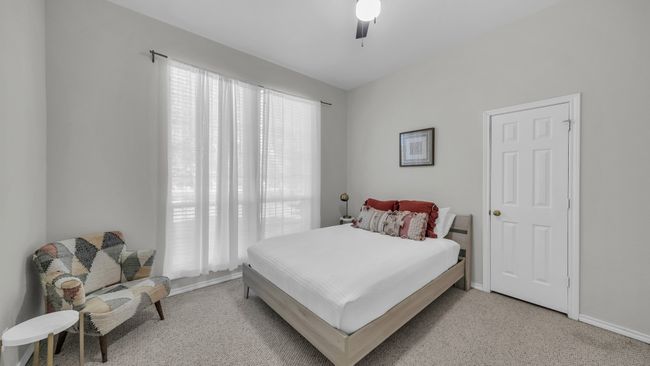 Bedroom featuring light colored carpet and a ceiling fan | Image 18