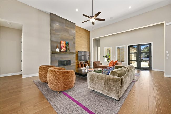 Living room with a tiled fireplace | Image 7