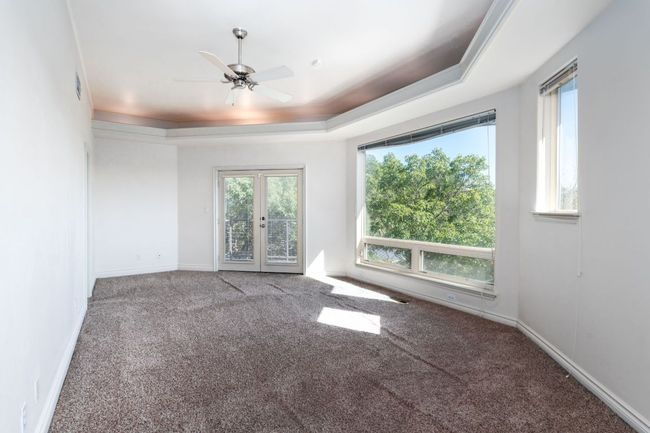 Room feature French doors that open to a beautiful balcony. | Image 14