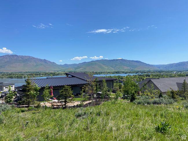 View of mountain backdrop featuring a nearby body of water | Image 92