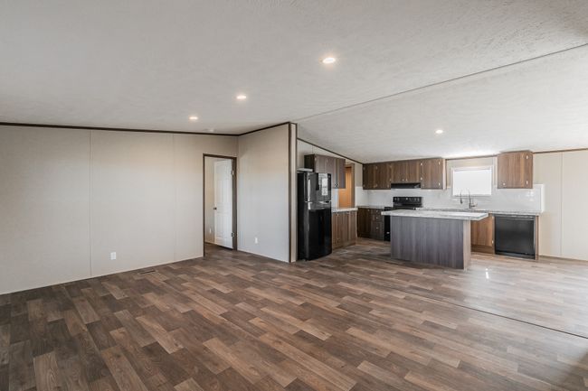 Kitchen is adjacent to the living room. | Image 10