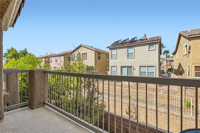 Balcony off of the primary bedroom suite (above the backyard covered patio) at 7143 Cabin Fever St Unit 102 | Image 16