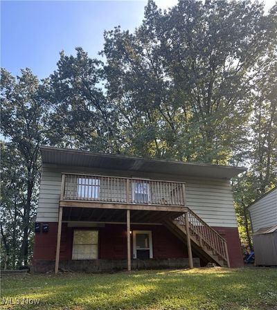 Back of house with a yard and a wooden deck | Image 1