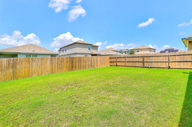 Fenced backyard featuring a residential view | Image 34