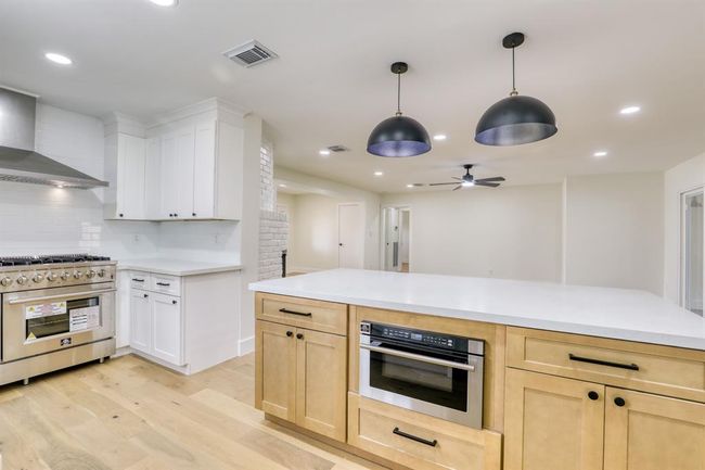 Island has even more storage and large microwave with sliding drawer. | Image 16