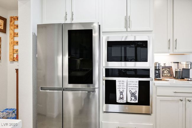 Kitchen featuring white cabinetry, stainless steel appliances, and light countertops | Image 17