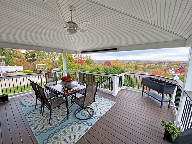 Wonderful newer rear deck - "TimberTech" composite flooring and vinyl railings, a vaulted ceiling, and steps to the rear yard. | Image 23