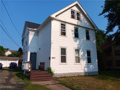 View of front of home featuring a garage and a front yard | Image 1