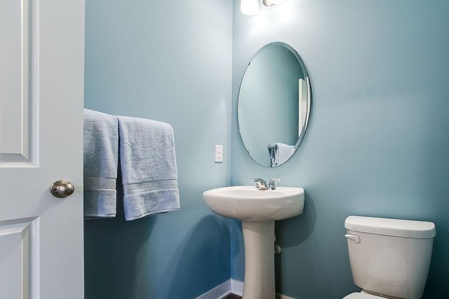 The Finnegan's main level also holds a half bath perfect for guest use without stairs! Photos of model home. Colors and options may vary. Ask Sales Agent for details. | Image 17
