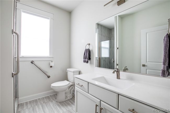 Bathroom with oversized vanity, plenty of natural light, and toilet | Image 38