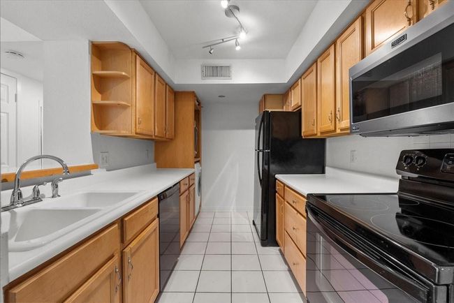 Bright kitchen with ample cabinet space | Image 11