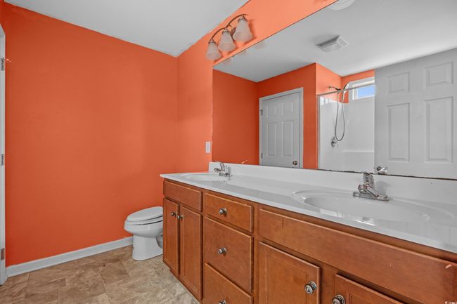 Full bath with baseboards, toilet, a shower, and double vanity | Image 30