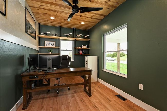 Office featuring wood ceiling, ceiling fan, plenty of natural light, light LVP finished floors. | Image 12