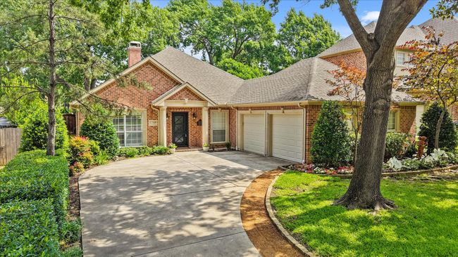 View of front of house featuring brick siding, a garage, concrete driveway, roof with shingles, and a chimney | Image 4