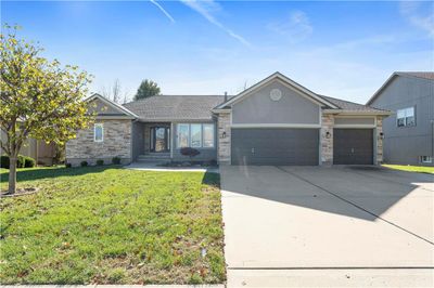 Single story home featuring a garage and a front yard | Image 2