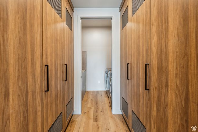 Spacious closet with visible vents, washer and clothes dryer, and light wood-style floors | Image 41