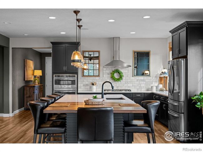 Extended center island in kitchen for informal dining and entertaining | Image 7