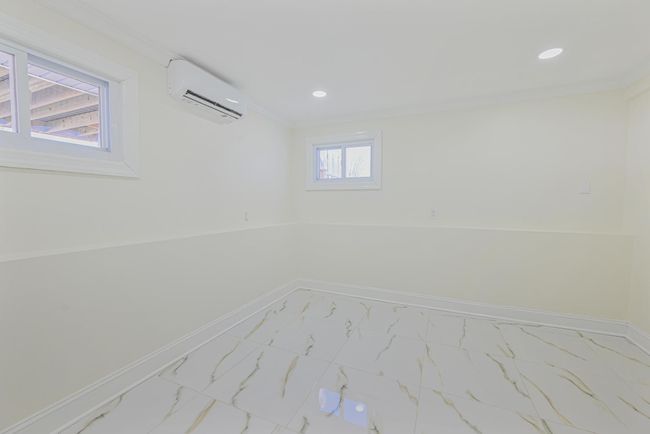 Empty room with crown molding and a wall unit AC | Image 37