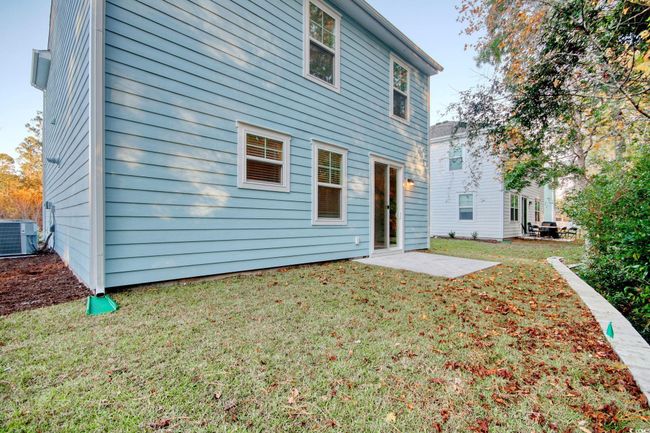 Rear view of property featuring central AC and a lawn | Image 19
