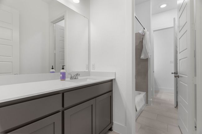 Full bath featuring vanity and shower / bath combo with shower curtain | Image 16