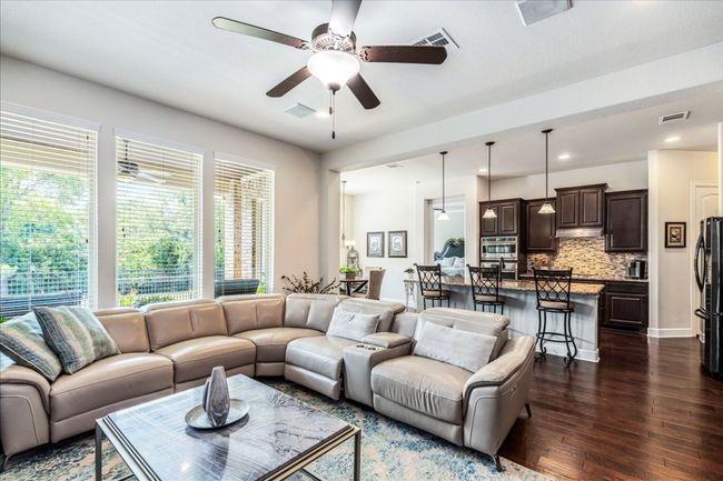 Living room featuring ceiling fan, dark wood-type flooring, and recessed lighting | Image 9