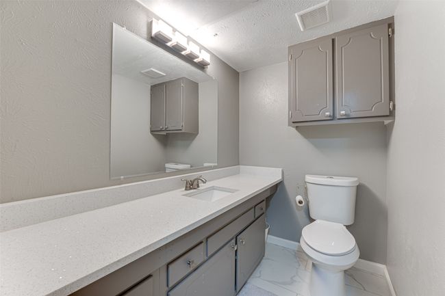 Bathroom with vanity, baseboards, toilet, visible vents, and marble finish floor | Image 18